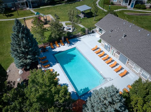 arial view of a swimming pool in front of a house